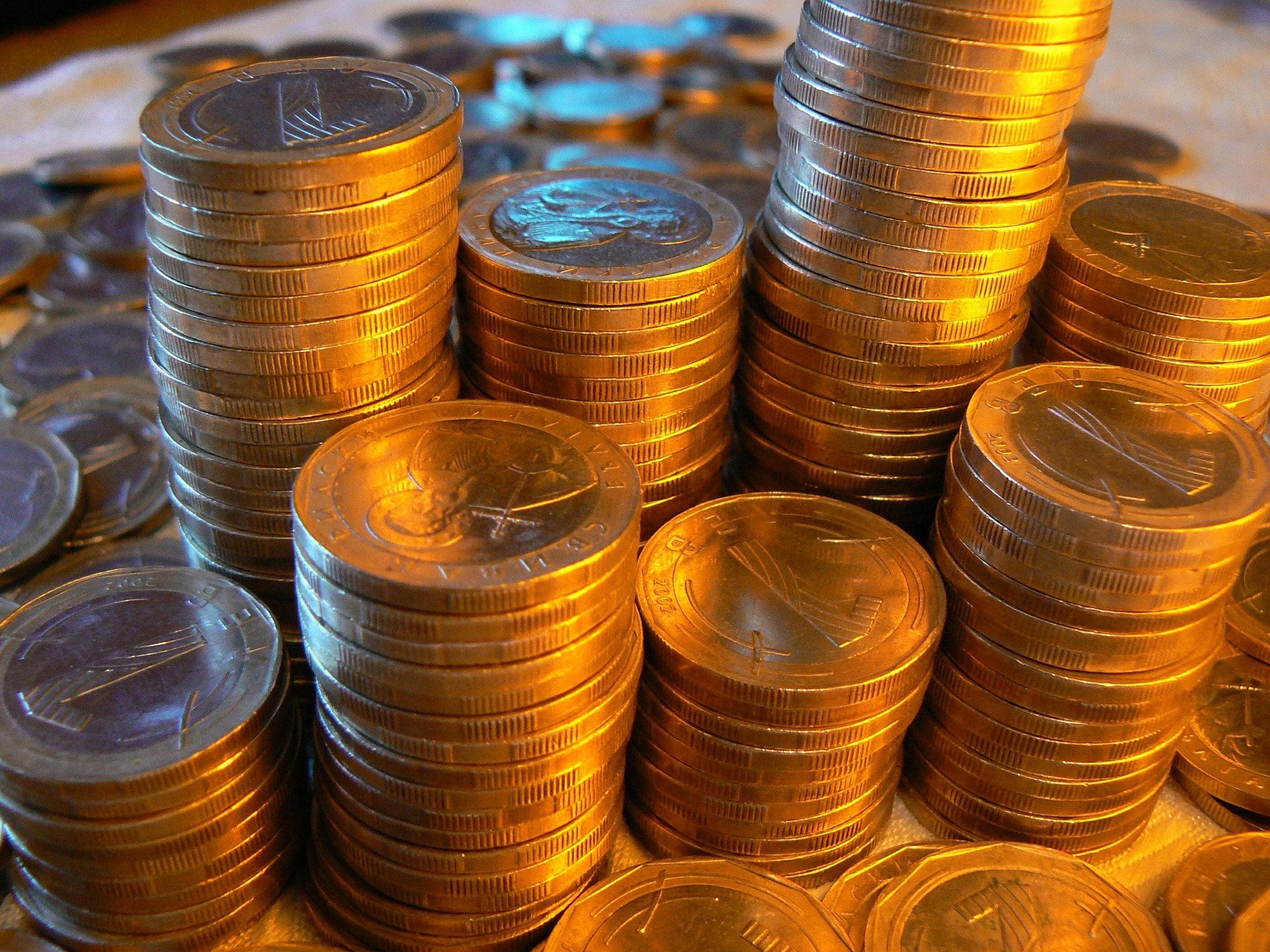 A table stacked with gold coins, enticing potential customers for affiliate sales.